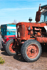 Fototapeta premium Old and shabby agriculture machine. Details of an old, red tractor. 