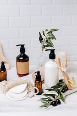 Shampoo shower gel Lotion, cream, massage brushes and anti-cellulite with bio olives on the table. Body and face care beauty bath set