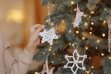 Decorated Christmas tree on blurred background.