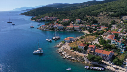 Fototapeta na wymiar Aerial drone photo from iconic picturesque fishing village and bay of Fiskardo with beautiful traditional houses of Ionian architecture, Cefalonia island, Greece