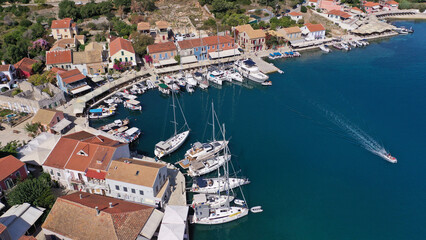 Fototapeta na wymiar Aerial drone photo from iconic picturesque fishing village and bay of Fiskardo with beautiful traditional houses of Ionian architecture, Cefalonia island, Greece