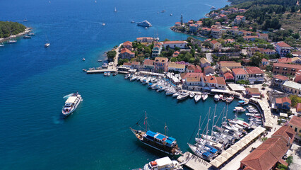 Aerial drone photo from iconic picturesque fishing village and bay of Fiskardo with beautiful traditional houses of Ionian architecture, Cefalonia island, Greece