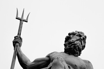 The mighty god of water, sea and oceans Neptune (Poseidon, Triton). Neptun's trident as symbol strength, power and unrestraint. Fragment of an ancient statue. Black and white image. © zwiebackesser