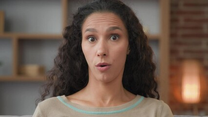 Close up portrait shocked amazed Hispanic Latino Caucasian woman 30s lady with big eyes say wow shock of unexpected news victory looking at camera with wonder delight facial reaction on prize indoors
