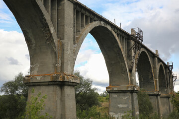 Fototapeta premium View of the abandoned old Mokrinsky railway bridge. Russia, the village of Mokry, the bridge was built in 1918