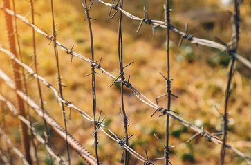 barbed wire stretched in on the fence