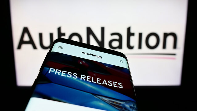 Stuttgart, Germany - 10-30-2022: Mobile phone with website of American automotive retail company AutoNation Inc. on screen in front of logo. Focus on top-left of phone display.