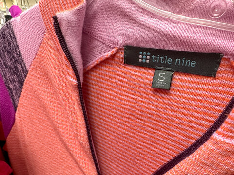 New Hope, Minnesota - November 6, 2022: Close Up Of A Title Nine Brand Clothing Tag. This Is A Sportswear Line