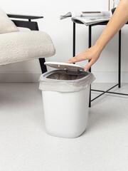 Gray plastic bucket. Cleanliness in the house. Trash can with lid for kitchen, living room or...