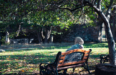 person sitting on a bench in the park