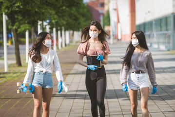 Young female Friends meeting outdoors coronavirus during pandemic flu - Asian girls wearing face masks for covid-19 quarantine