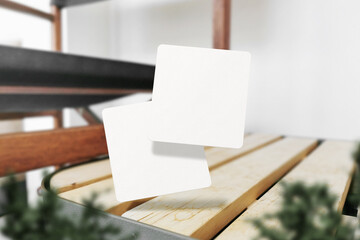 Clean minimal square flyer mockup floating on top storage bin with plant foreground