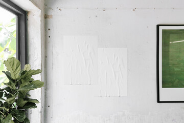 Clean minimal poster mockup on the wall with framwork and plant background