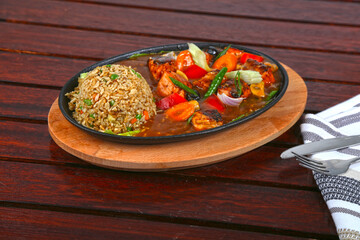 Salmon Sizzling With Brown Fried Rice served in dish isolated on table side view of middle east food