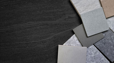 multi color of grainy artificial stones (quartz) and stone tiles samples placed on dark black...