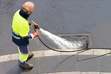 sewer workers working  for cleaning with water pressure on maintenance by the system sewage in city...