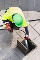 sewer workers working  for cleaning with water pressure on maintenance by the system sewage in city...
