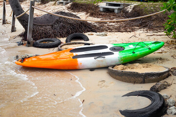 Board for riding on the water with a paddle on the seashore. Leisure and entertainment on vacation