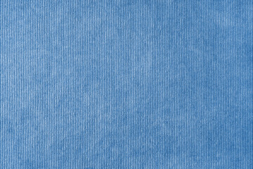 Fototapeta na wymiar Texture background of velours blue fabric. Upholstery velveteen texture fabric, corduroy furniture textile material, design interior, decor. Ridge fabric texture close up, backdrop, wallpaper.