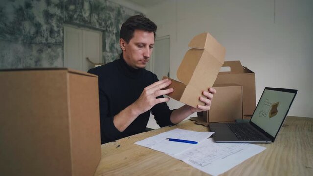 Freelance work at home. Designer creates carton packaging design on computer