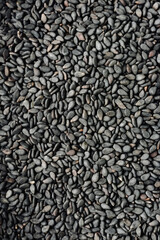 Black sesame seeds textured background.