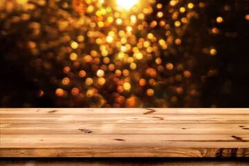 Empty wooden table for product placement or montage with focus to the table top blurred bokeh background, suitable for montage product
