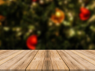 Empty wooden tabletop and blur room with a Christmas tree background, suitable for montage product