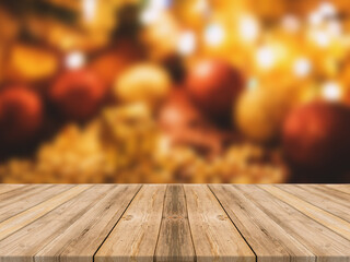 Empty wooden tabletop and blur room with a Christmas tree background, suitable for montage product