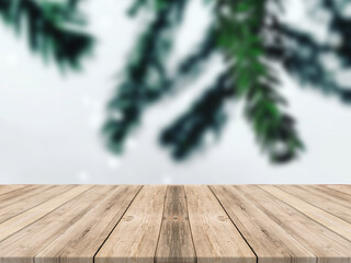 Empty wooden tabletop and blur room with a Christmas tree background, suitable for montage product