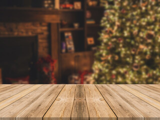 Empty wooden tabletop and blur room with a Christmas tree background, suitable for montage product
