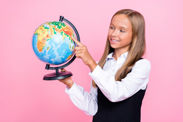 Photo of young cute smart pretty schoolgirl wear uniform september back school finger point globe...
