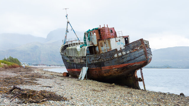 The Corpach Wreck.  A wrecked and abandoned trawler on the banks of Loch Eil, North West Scotland with Ben Nevis Mountain in the background.