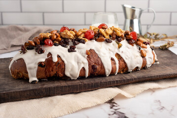 sweet bread for the Christmas holidays round and oval with dry fruits walnuts almonds cream icing...