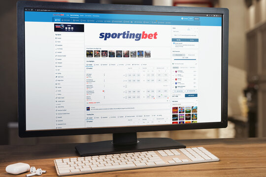 Sportingbet betting website on computer screen. Monitor, keyboard and airpods on wooden table. Selective focus. Rio de Janeiro, RJ, Brazil. November 2022