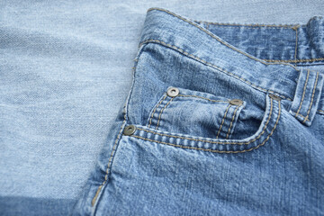 Fototapeta premium Lots of jeans pants in a stack. Denim background.