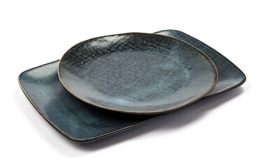 ceramic dark blue flat square and round plate with black blotches (dots, paint splashes, spots) close-up on white background