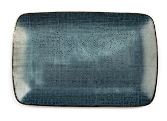 ceramic dark blue flat square plate with black blotches (dots, paint splashes, spots) close-up on white background