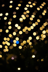 defocused christmas garlands of glowing yellow light bulbs. Abstract festive background