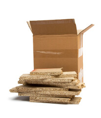 a pile of construction debris (plastic, MDF, aluminum, cardboard) in a brown cardboard box on a...
