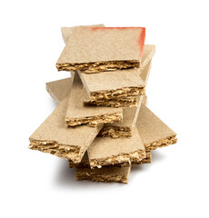 a pile of broken untreated mdf slabs of brown color on a white background close-up
