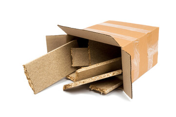a pile of construction debris (plastic, MDF, aluminum, cardboard) in a brown cardboard box on a white background