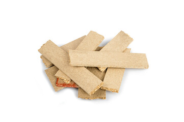 a pile of broken untreated mdf slabs of brown color on a white background close-up