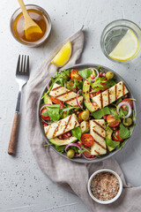 Salad with fried Halloumi cheese, cherry tomatoes, arugula and pomegranate seeds. healthy food. vertical photo