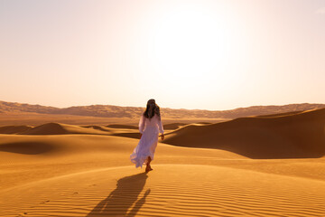 UAE. Woman in desert - obrazy, fototapety, plakaty
