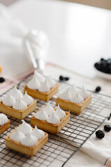 Fototapeta na wymiar meringue desserts with delicious berries and fruits in the kitchen. High quality photo