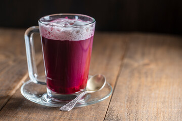 Beetroot vanilla latte from fresh beetroot juice blended with vanilla and milk in a transparent cup...
