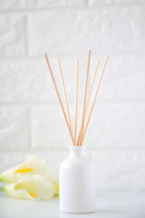 Fototapeta na wymiar The aroma reed diffuser with the stick perfume are decorated in the room minimal design idea