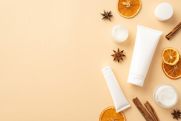Natural cosmetics concept. Top view photo of white tubes without label cream jars dried orange...