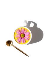 Golden milk in a white cup decorated with a pink daisy. Anti-inflammatory drink. Golden milk with white background and copy space