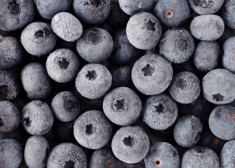 Blueberry berry. Frozen blueberries covered with white frost, top view.